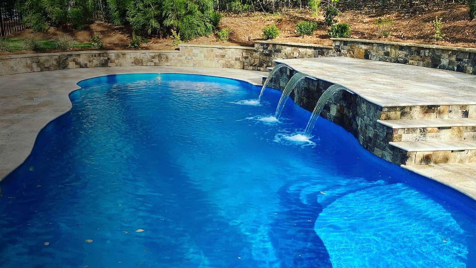 inground fiberglass pool with three waterfall ledge